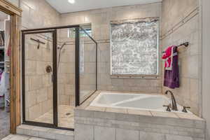 Bathroom with a garden tub, a shower stall, and a spacious closet