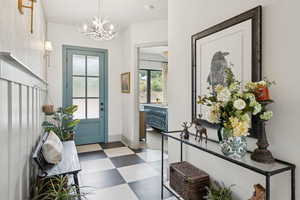 Foyer entrance featuring a chandelier and tile patterned floors