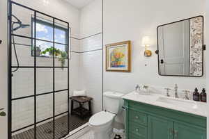 Bathroom with vanity, a tile shower, and tile patterned floors