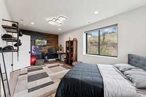 Bedroom featuring wood finished floors, recessed lighting, and a desk