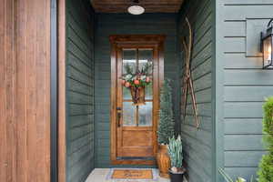 View of exterior entry featuring a porch