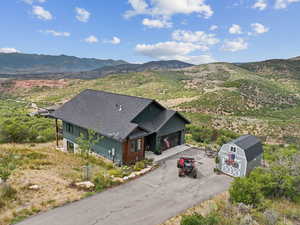 Aerial view of property and surrounding area featuring mountains