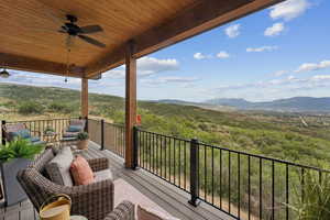 Balcony with outdoor lounge area, a mountain view, and a ceiling fan