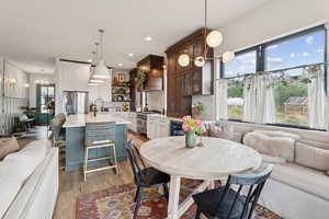 Dining space with light wood finished floors, recessed lighting, and a chandelier