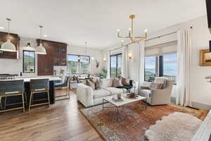 Living area with a chandelier, recessed lighting, and light wood-style floors