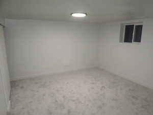 Empty room with carpet floors and baseboards