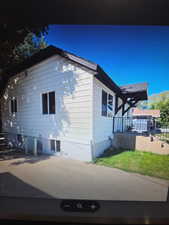 View of side of property with a wooden deck