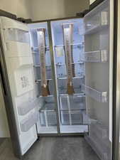 Detailed view of fridge and wood finished floors