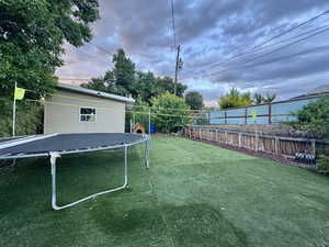 View of yard featuring a trampoline