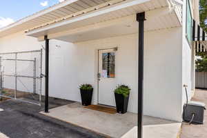 Doorway to property featuring concrete block siding