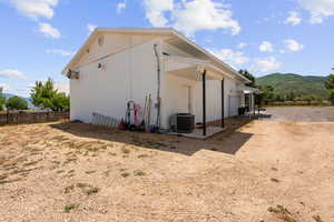 Rear view of house with a mountain view and a patio