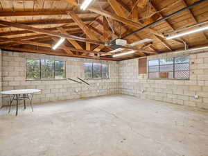 Large concrete block garage with ample electricity and 220 amp