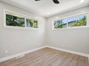 Bedroom room featuring light wood finished floors, a ceiling fan, and recessed lighting