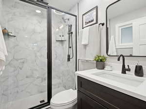 Primary bathroom with vanity, tiled shower with rainhead
