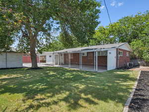 Back of property featuring a patio and brick siding. Brand new sod and new roof