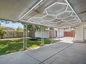 Backyard with a patio area, garage, and a shed