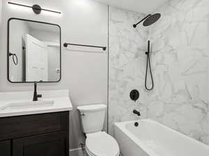 Hall bathroom with vanity and bath tub and tiled shower combination