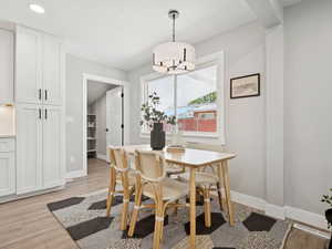Dining area with light wood-style flooring and baseboards