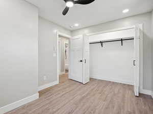 Bedroom featuring light wood-style flooring, lighted closet, ceiling fan and recessed lighting.