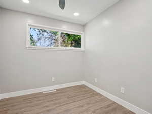 Bedroom room with wood finished floors, recessed lighting, and a ceiling fan