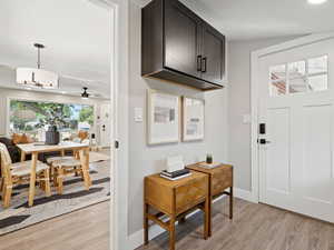 Back entrance featuring light wood-style floors and a ceiling fan