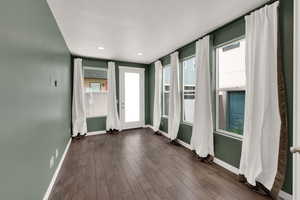 Entryway with dark wood finished floors and recessed lighting