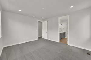 Unfurnished bedroom featuring carpet, recessed lighting, and connected bathroom