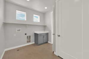 Washroom featuring electric dryer hookup, hookup for a washing machine, and recessed lighting