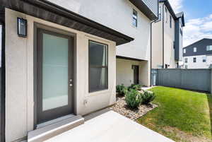 View of exterior entry featuring stucco siding