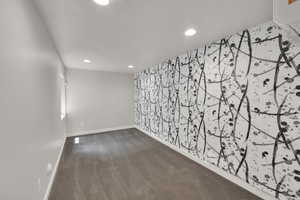 Spare room featuring dark colored carpet and recessed lighting