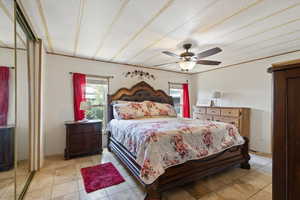Bedroom with light tile patterned floors and a ceiling fan