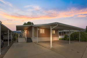 View of front of house featuring an attached carport and concrete driveway