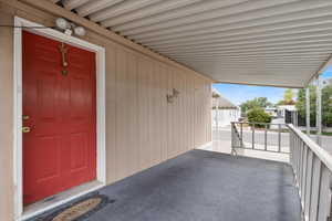 Property entrance featuring an attached carport