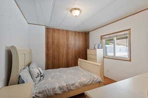Bedroom with wood finished floors.