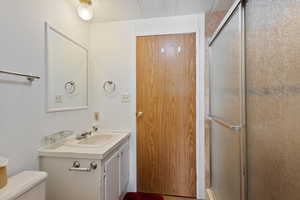 Full bath with vanity and a shower stall