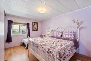 Bedroom featuring wood finished floors and a textured ceiling