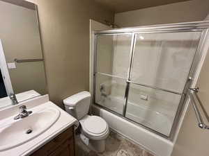 Bathroom with vanity and shower / bath combination with glass door