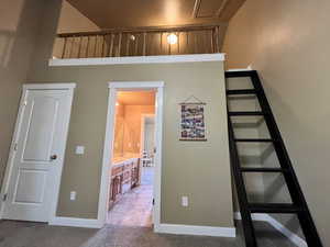 Stairway featuring carpet and baseboards