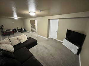 Living area featuring carpet floors and stairway