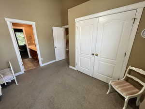 Bedroom with carpet floors, a closet, and ensuite bathroom