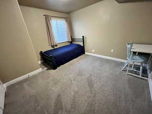 Unfurnished bedroom featuring baseboards and carpet flooring