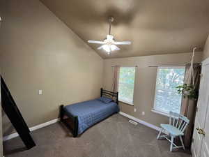 Bedroom featuring vaulted ceiling, carpet flooring, and a ceiling fan