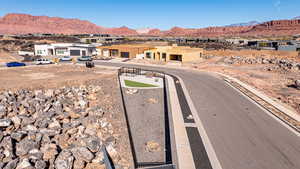 View of asphalt road with a mountain view, a residential view, and curbs
