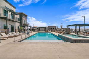 Community pool with a hot tub and a patio area