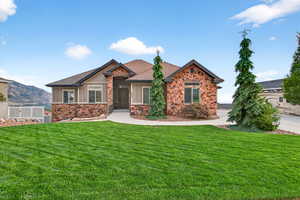 Craftsman-style home featuring stone siding, board and batten siding, and a shingled roof