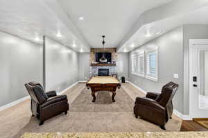 Game room featuring a fireplace, billiards table, and carpet floors