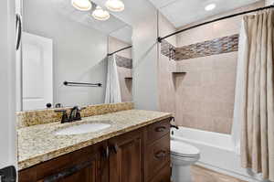 Full bathroom featuring vanity and shower / bath combination with curtain