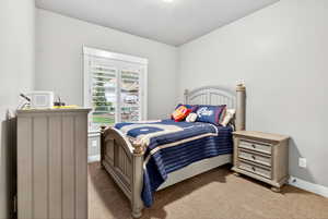 Bedroom featuring carpet flooring and baseboards