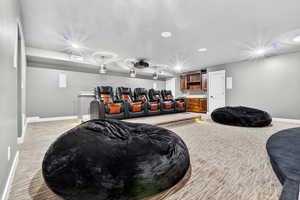 Cinema room featuring carpet floors