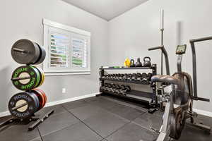 Workout area featuring baseboards
